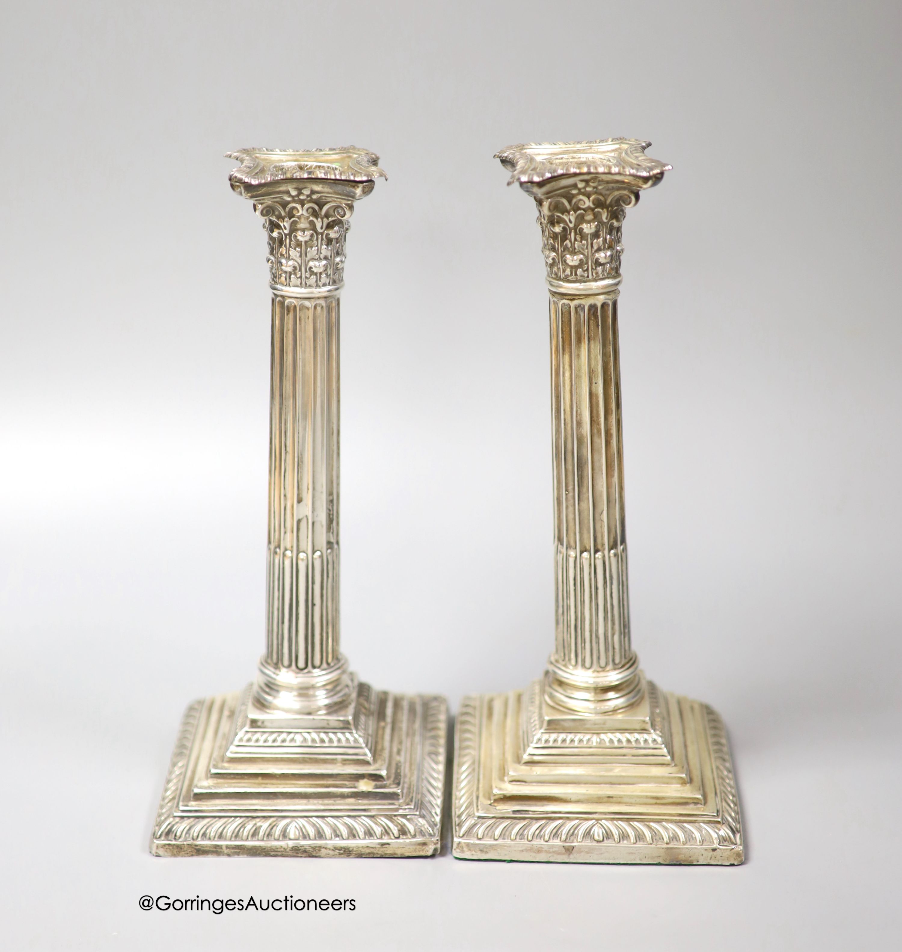 A pair of Edwardian silver corinthian column candlesticks, Walter Latham & Son, Sheffield, 1904, 24.5cm, weighted (a.f.).